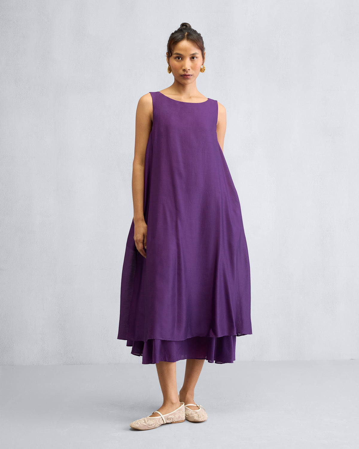 Person in a purple Chanderi A-line Double layer dress, hands at the sides.