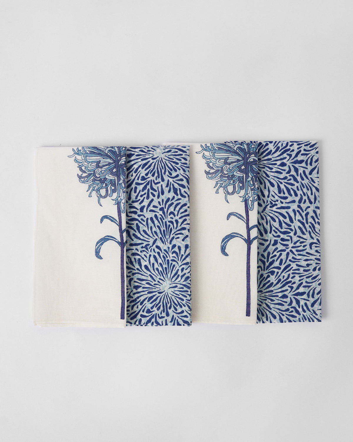 Chandramallika Dinner Napkins in white and blue with chrysanthemum prints.