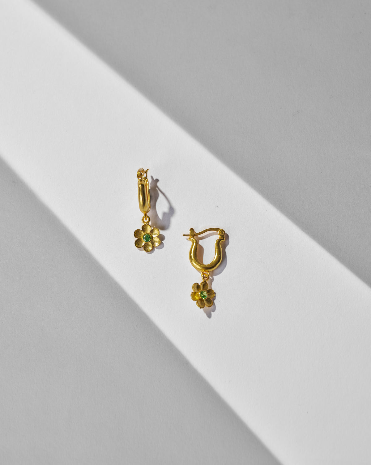 Pair of gold Raat Rani hoop earrings with green flower charms.