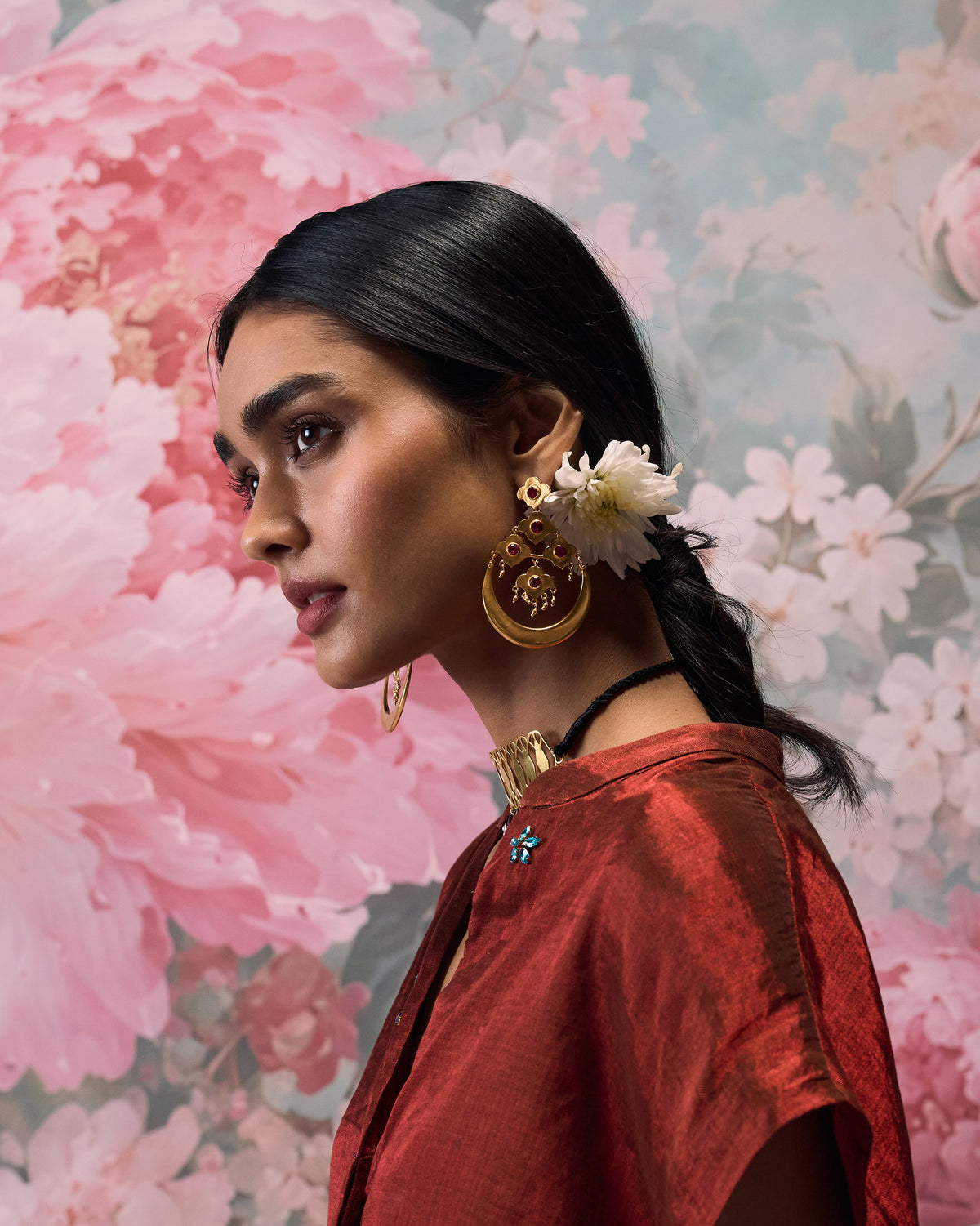 Side profile of gold Moon Flower earrings with red glass.