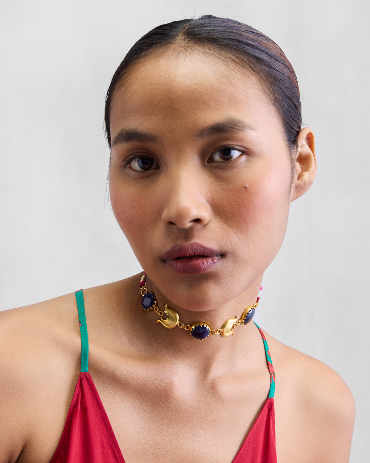 Person looking at the camera, wearing a gold Chandphool Choker.