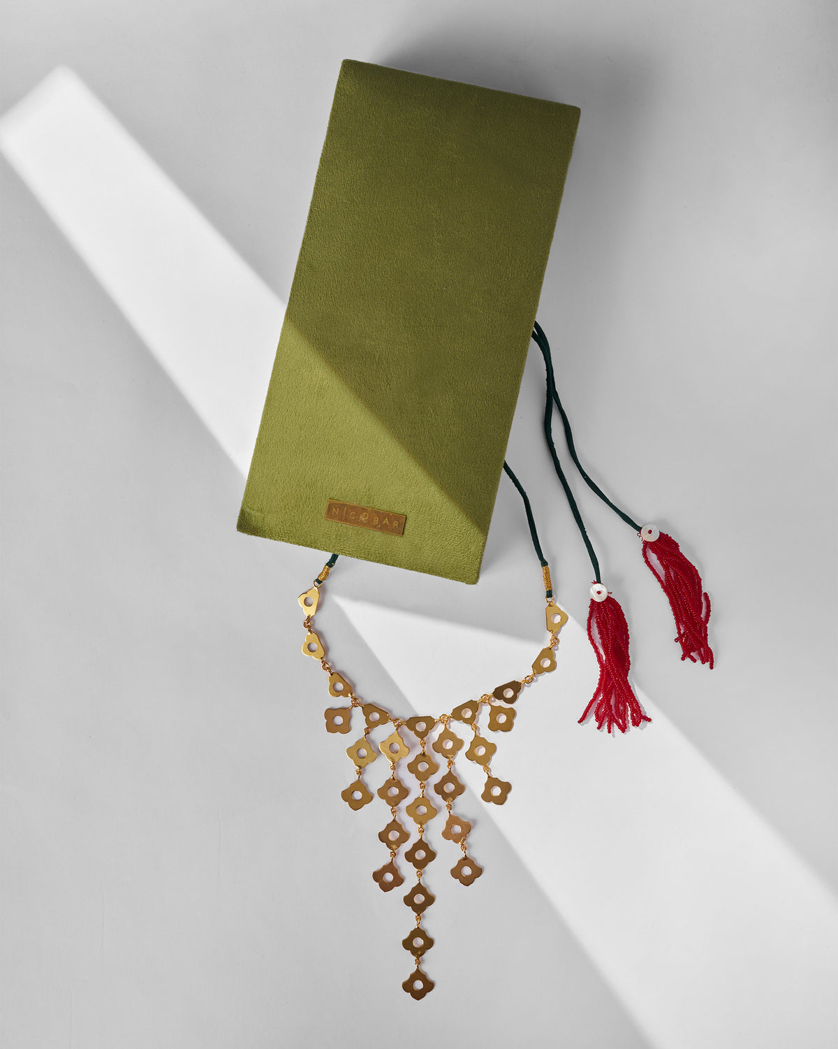 Gold Phool Jaal necklace with an olive Nicobar gift box.