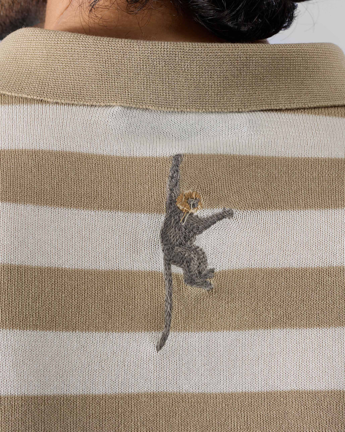 Close-up of the embroidered monkey on the back of a Macaque Polo.