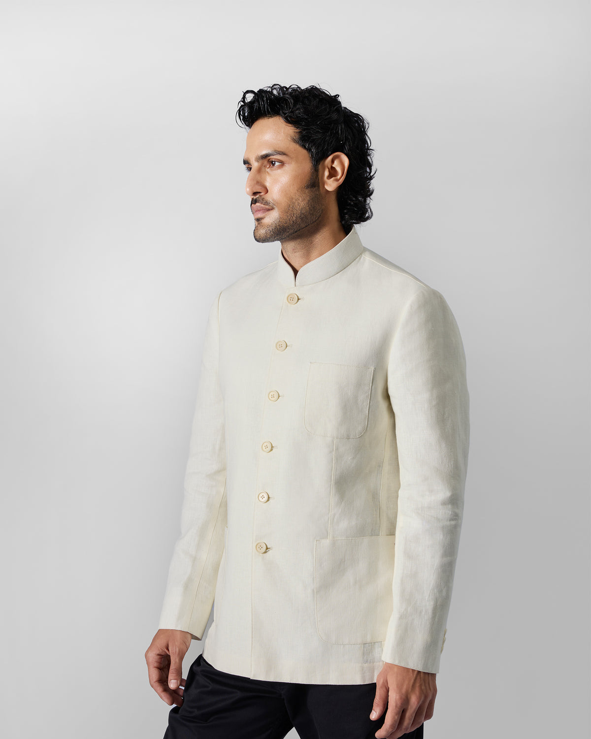 Three-quarter view of an ivory Tahr Bandhgala jacket worn by a person.