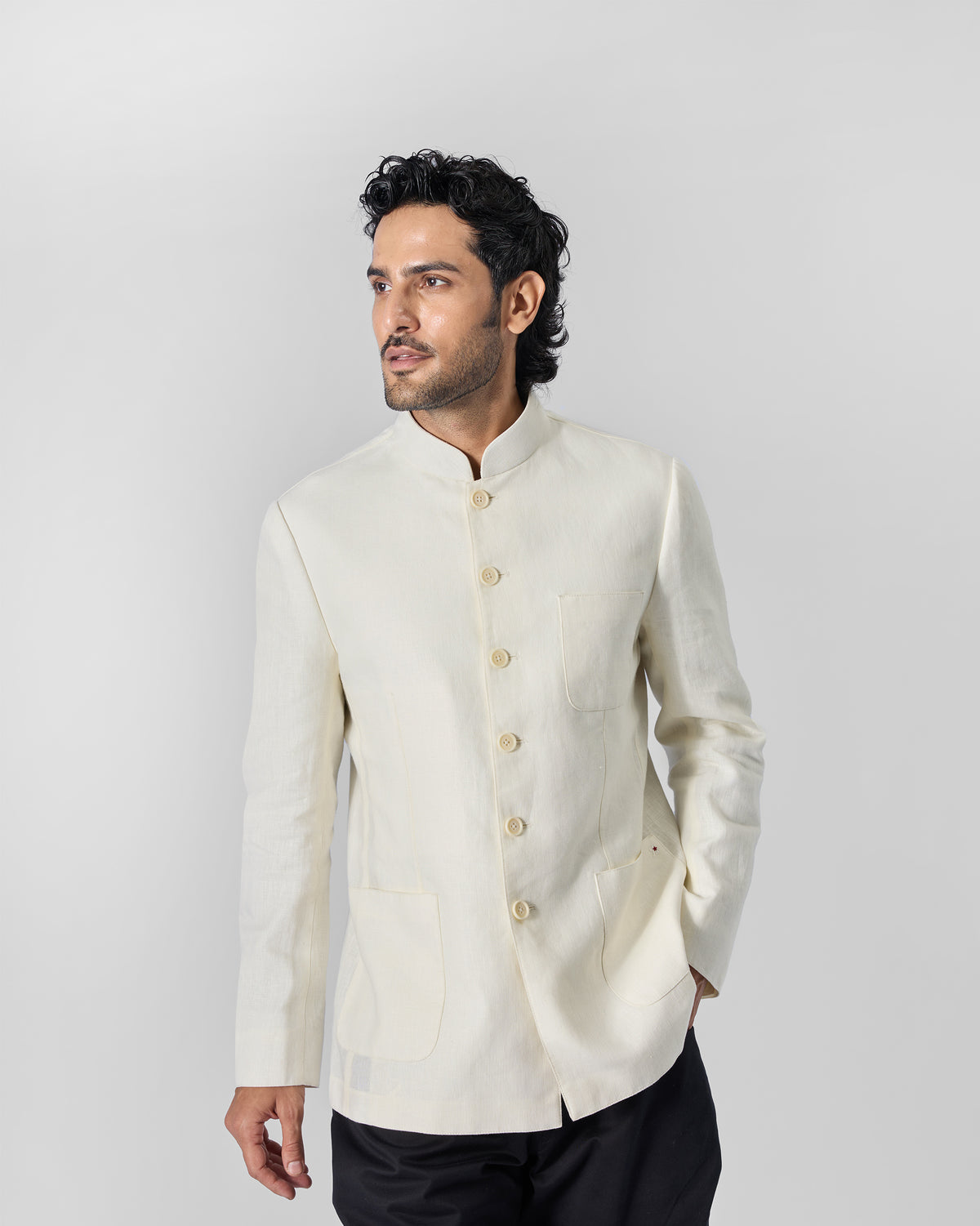 Full-length view of an ivory Tahr Bandhgala jacket worn by a person.