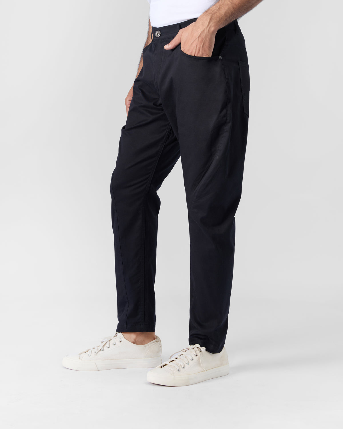 Side view of black Serow jodhpur pants tapering at the ankle.