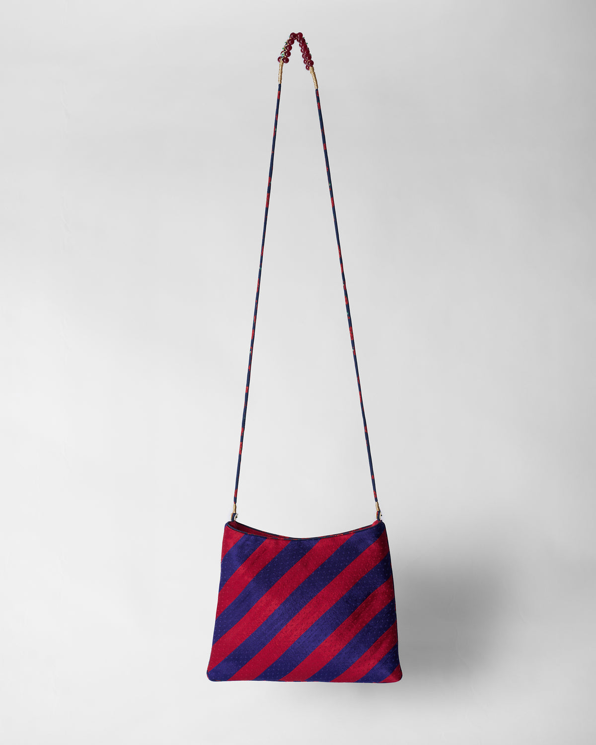 Back of the red and purple Muris Sling with a long thin strap.