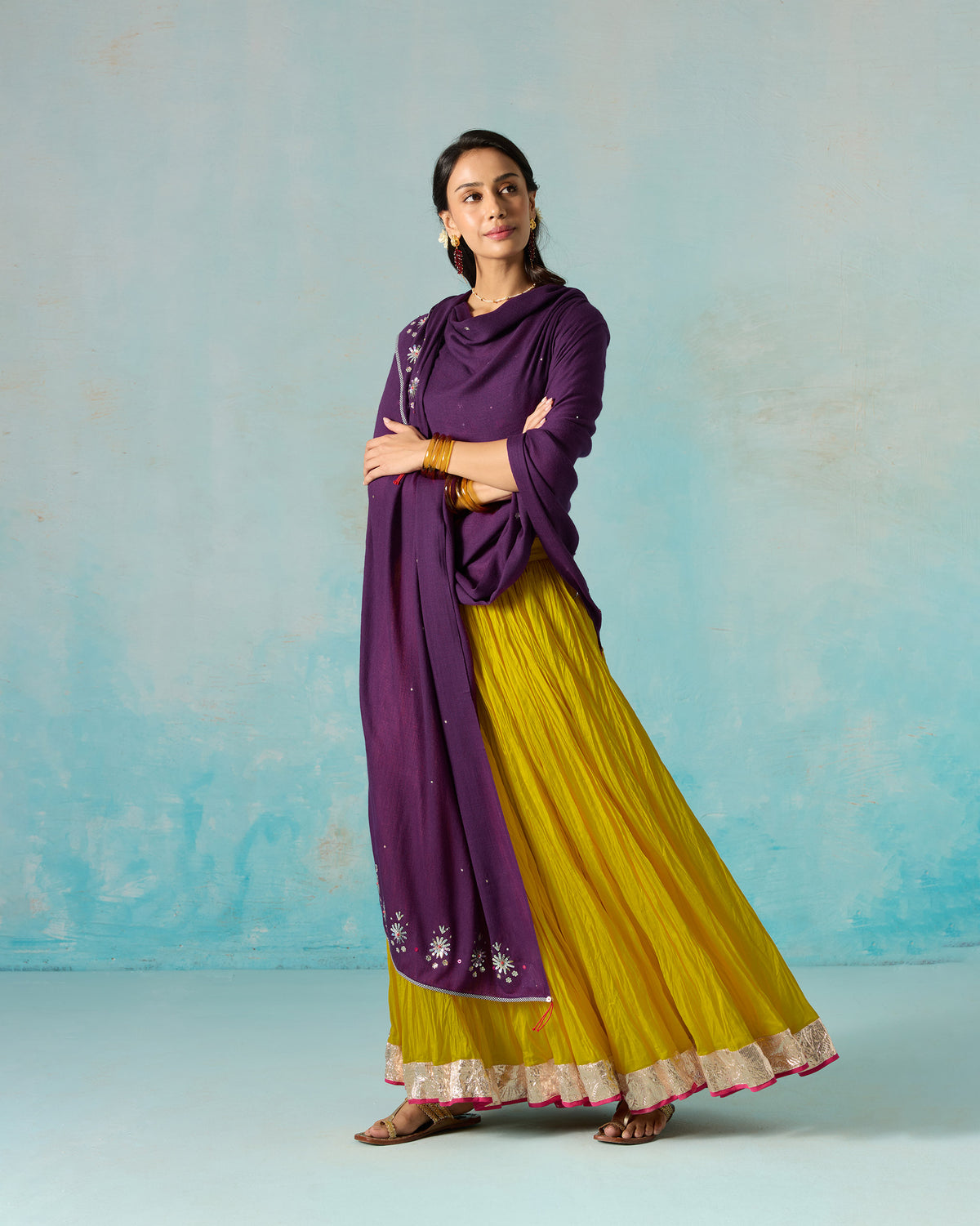 Person wearing a violet Bahaar shawl draped over the shoulders.