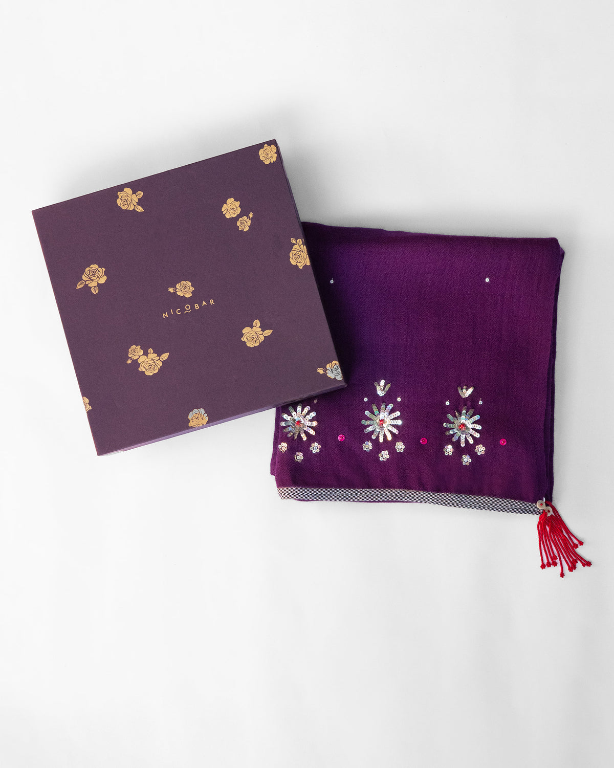 Violet Bahaar shawl folded beside a purple Nicobar gift box.