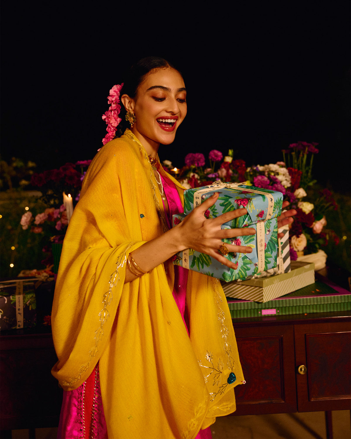 Person wearing a yellow Saanjh shawl with embroidered edging.