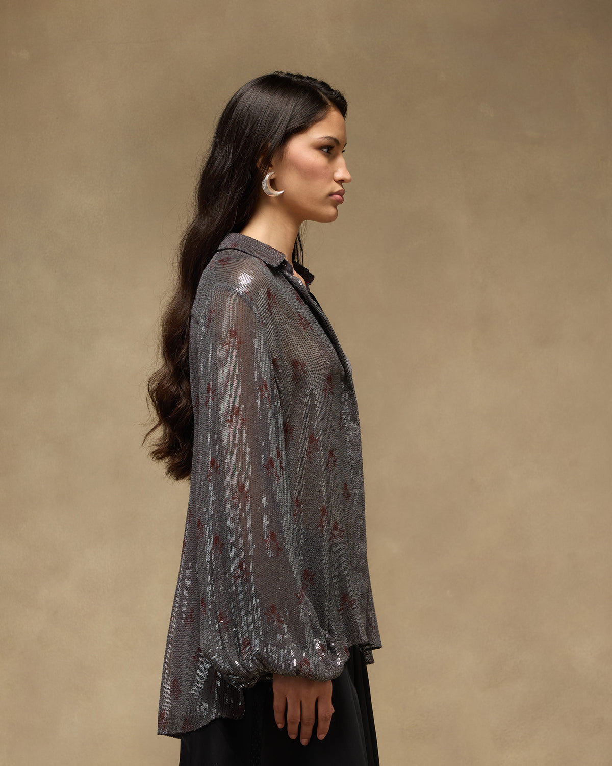 Side profile of a charcoal Bacchus sequined shirt with billowy sleeves.