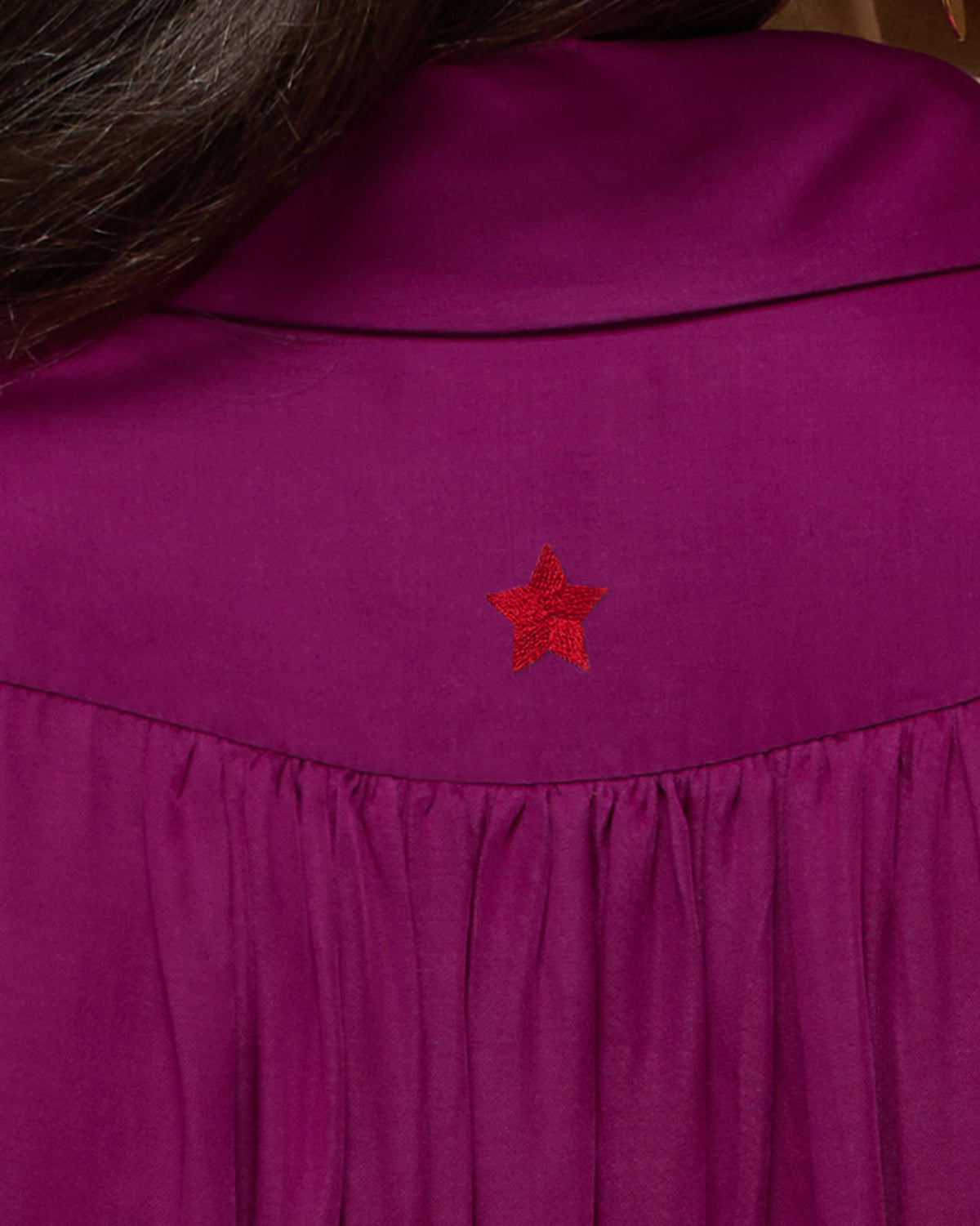 Close-up of purple Daydream Shirt showing a red star embroidery at the upper back.
