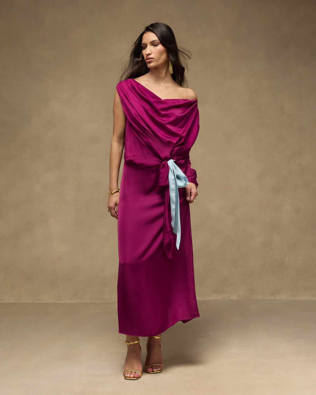 Person wearing a mulberry one-shoulder Fireside Dress with a powder blue waist tie.