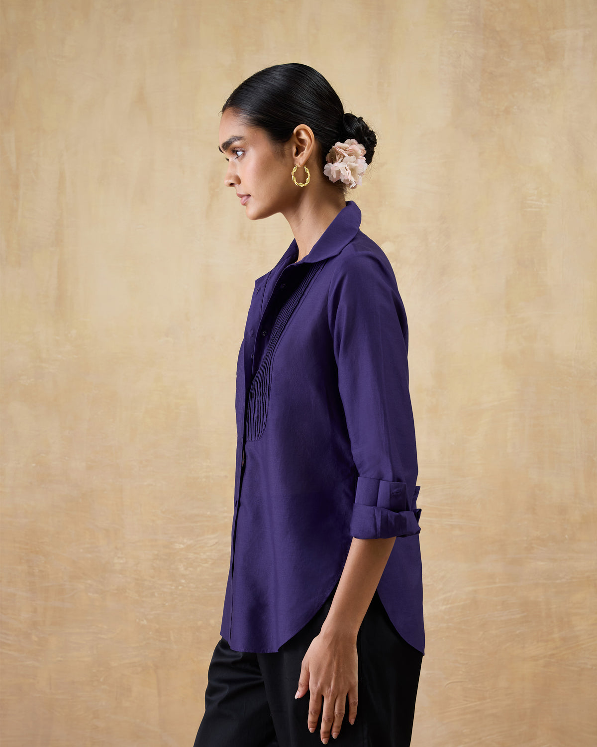 Side view of a purple Tuxedo Shirt showing the pintuck panel and curved hem.