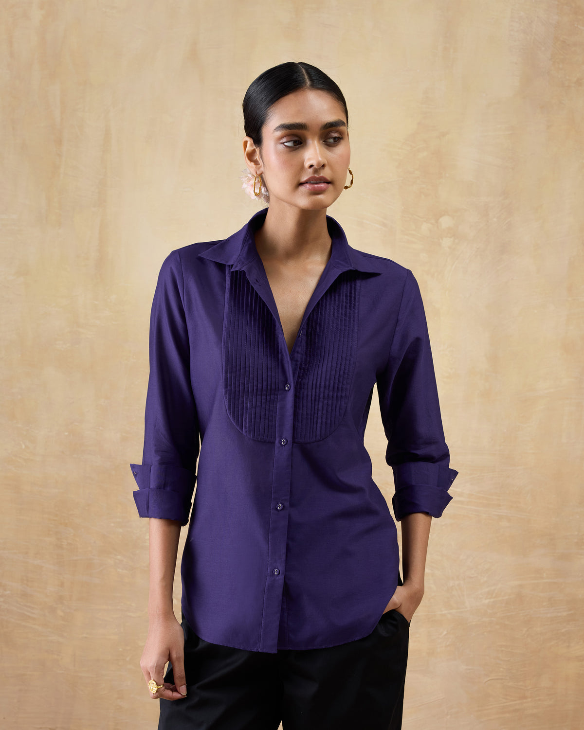 Person wearing a purple Tuxedo Shirt with rolled sleeves and a pintuck front.