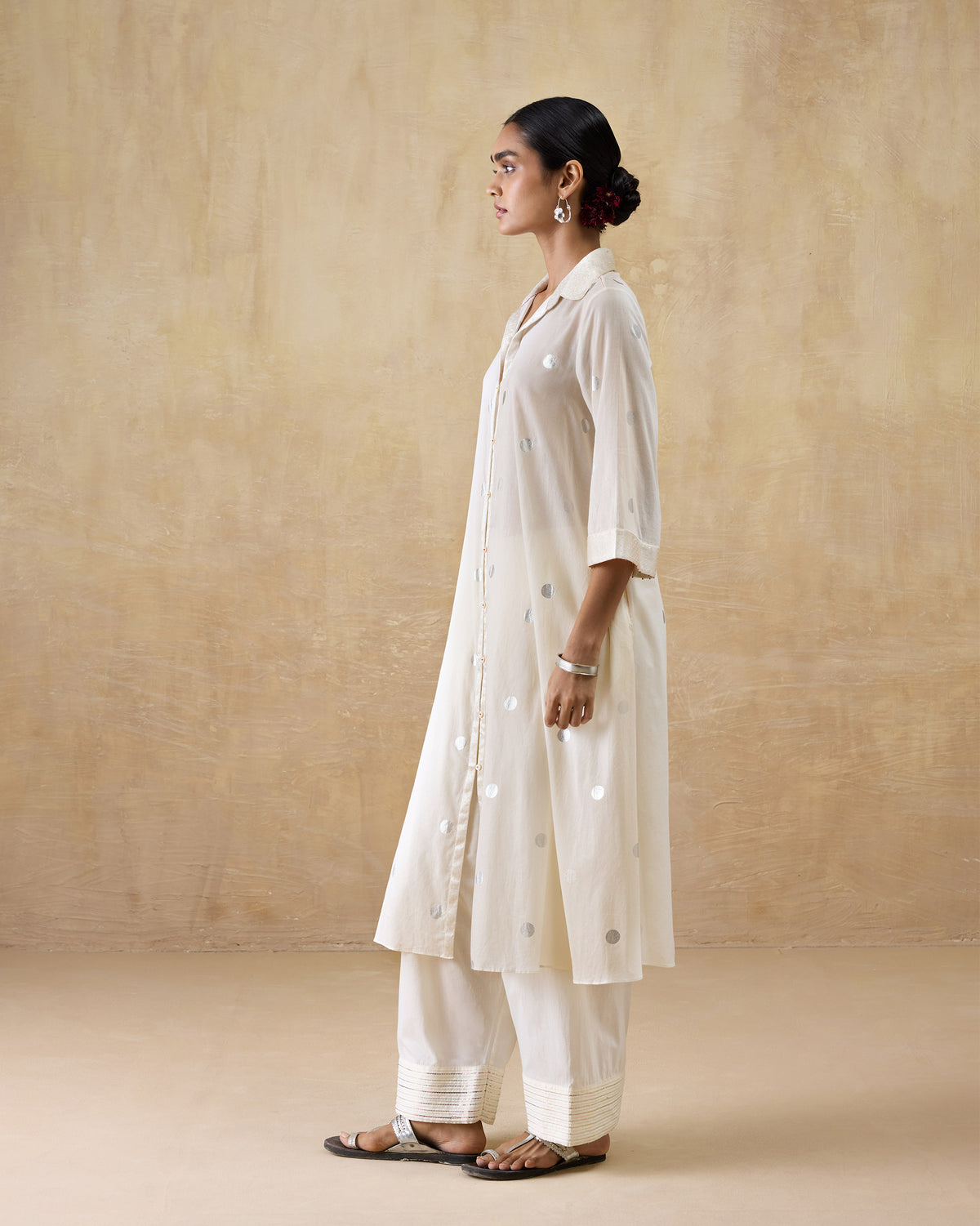 Side view of an ivory Rejoice kurta with silver polka dots.