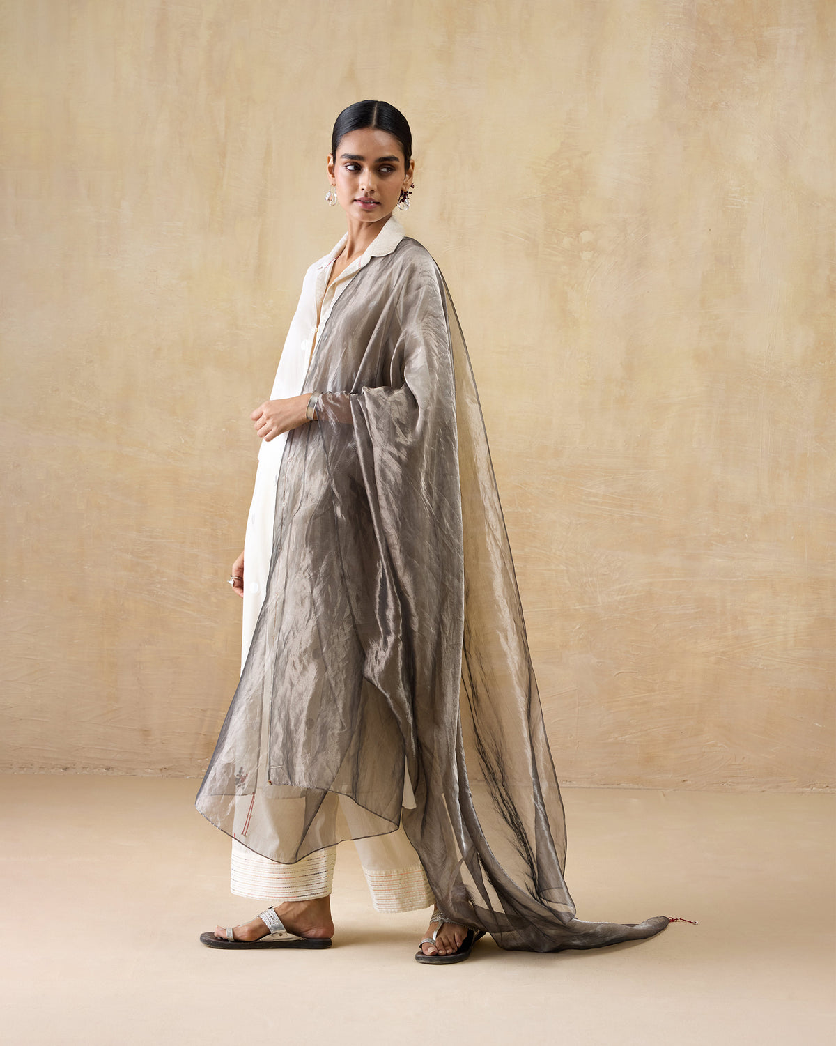 Person wearing an ivory Rejoice kurta with a metallic grey stole.