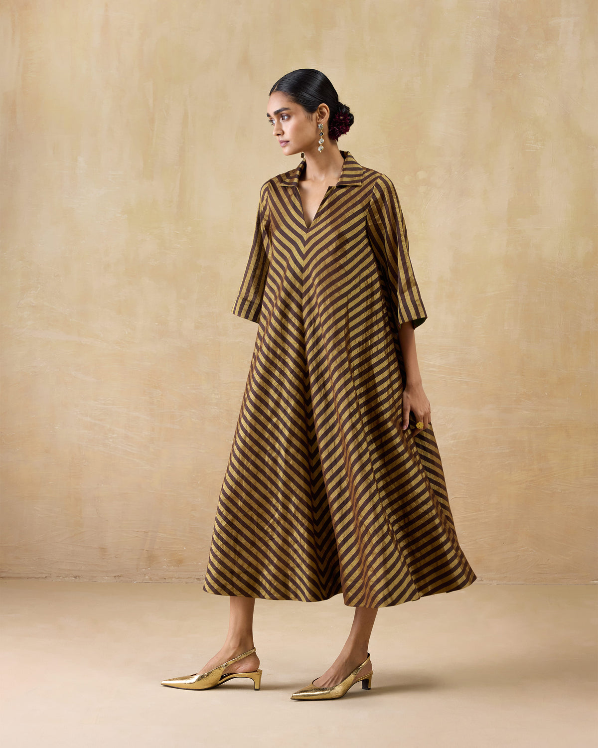 Chocolate and gold striped Areva Dress worn in an A-line midi length.