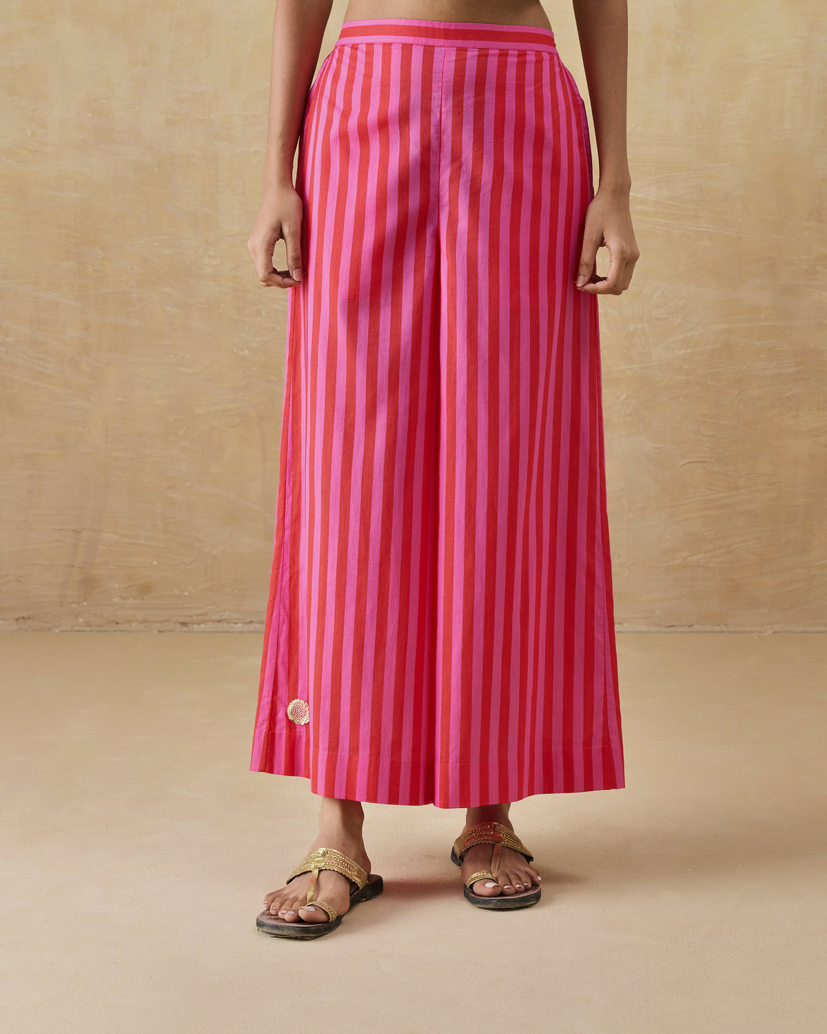 Person wearing red and berry striped Basic pyjamas with a wide A-line flare.