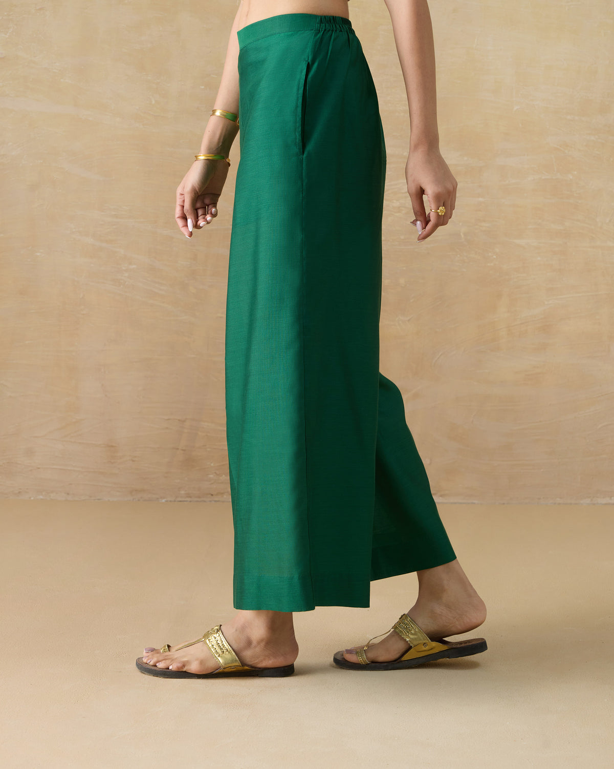 Side view of emerald green Basic pyjamas with a wide-leg silhouette.