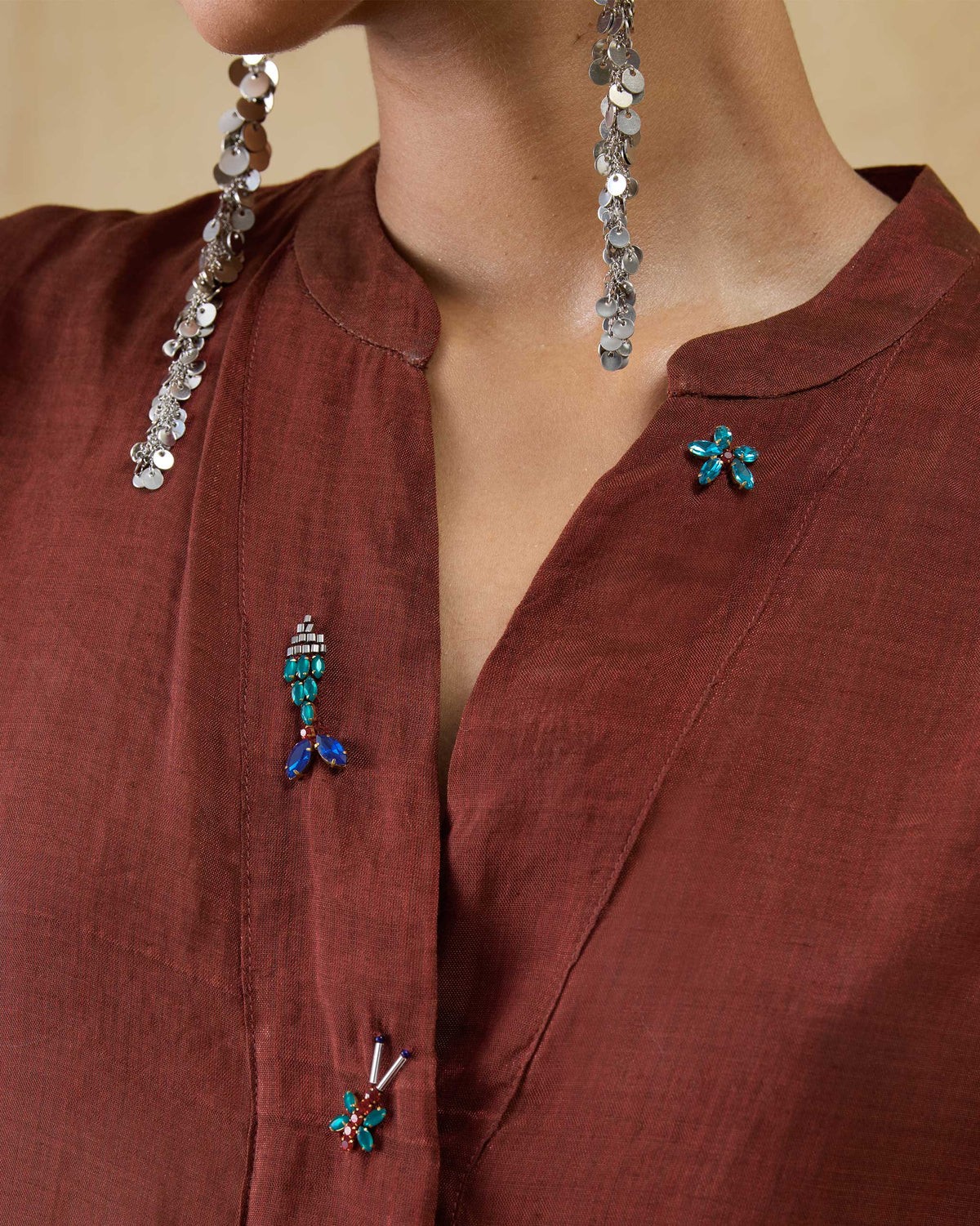 Close-up of a scarlet red kaftan neckline with jeweled embroidery.
