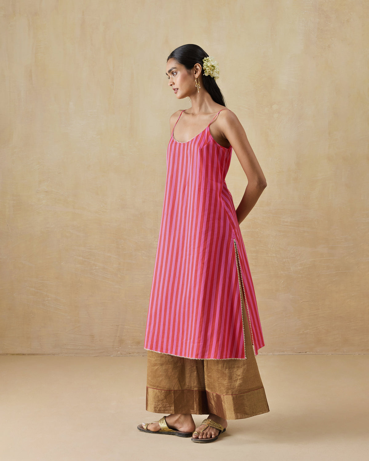 Side view of a red and berry striped Mist Camisole with a side slit.