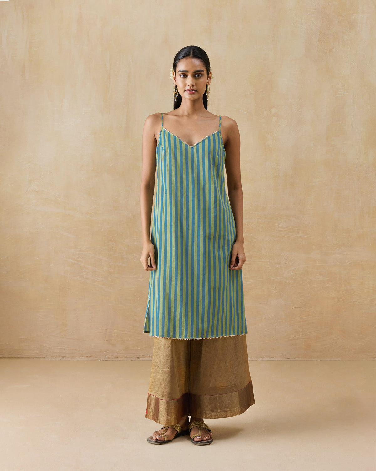 Person wearing a green and blue striped Mist camisole.