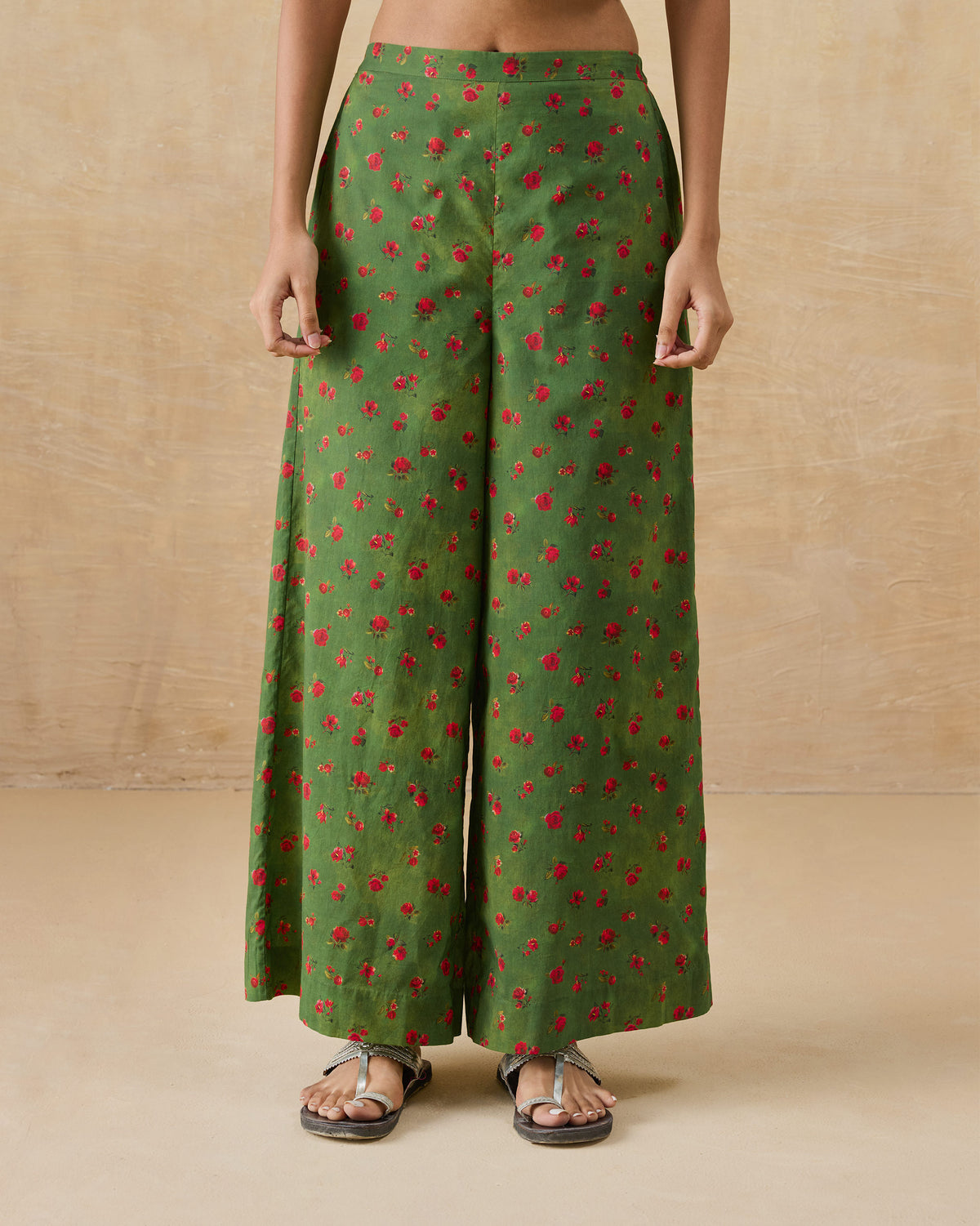 Person wearing olive green Basic pyjamas with a small rose print.