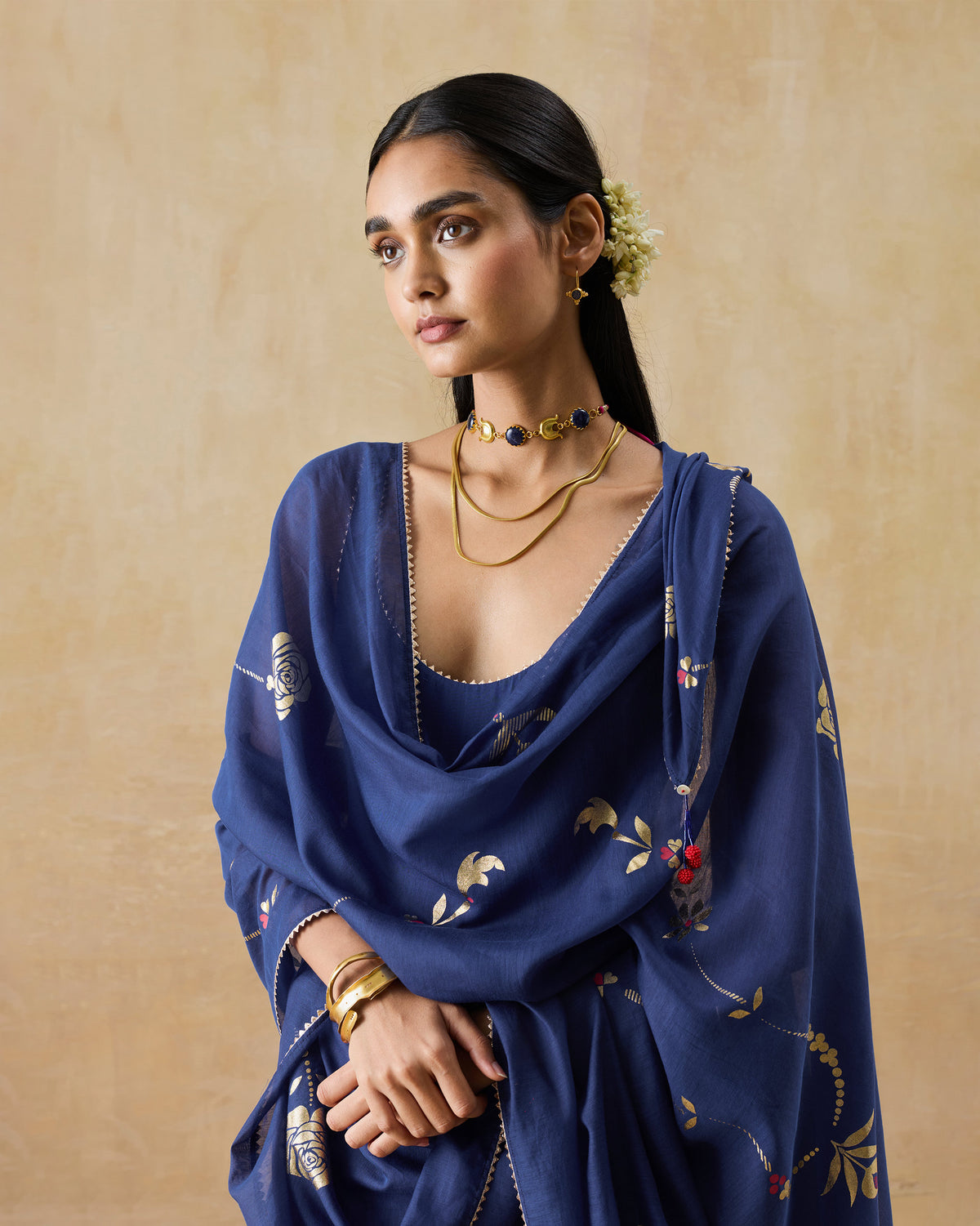 Person wearing a navy Glowgetter Dupatta with gold printed motifs.