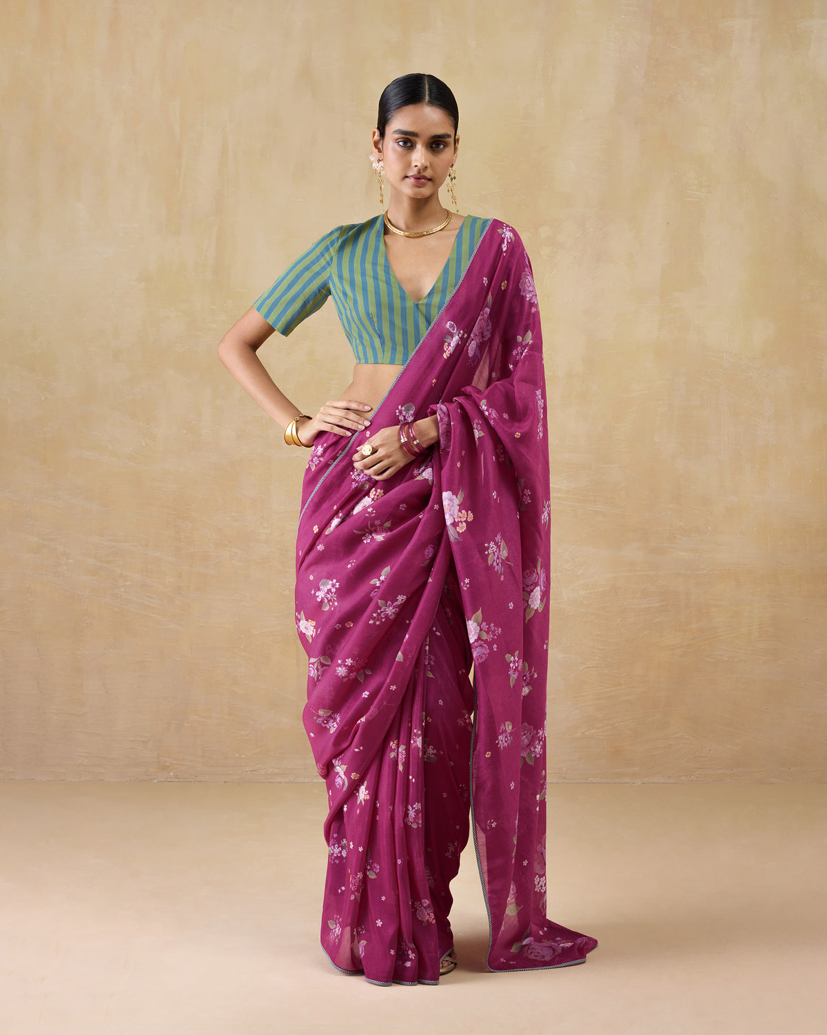 Person wearing a berry Speckle sari with a scattered floral print.