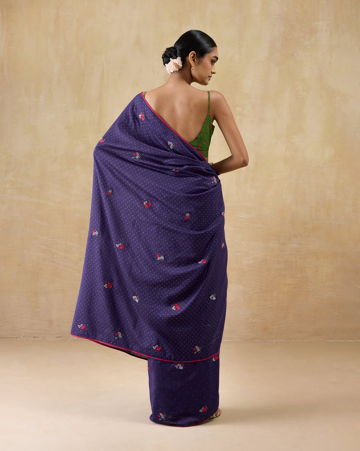 Back of a purple Midnight Dance Sari with a green sleeveless blouse.