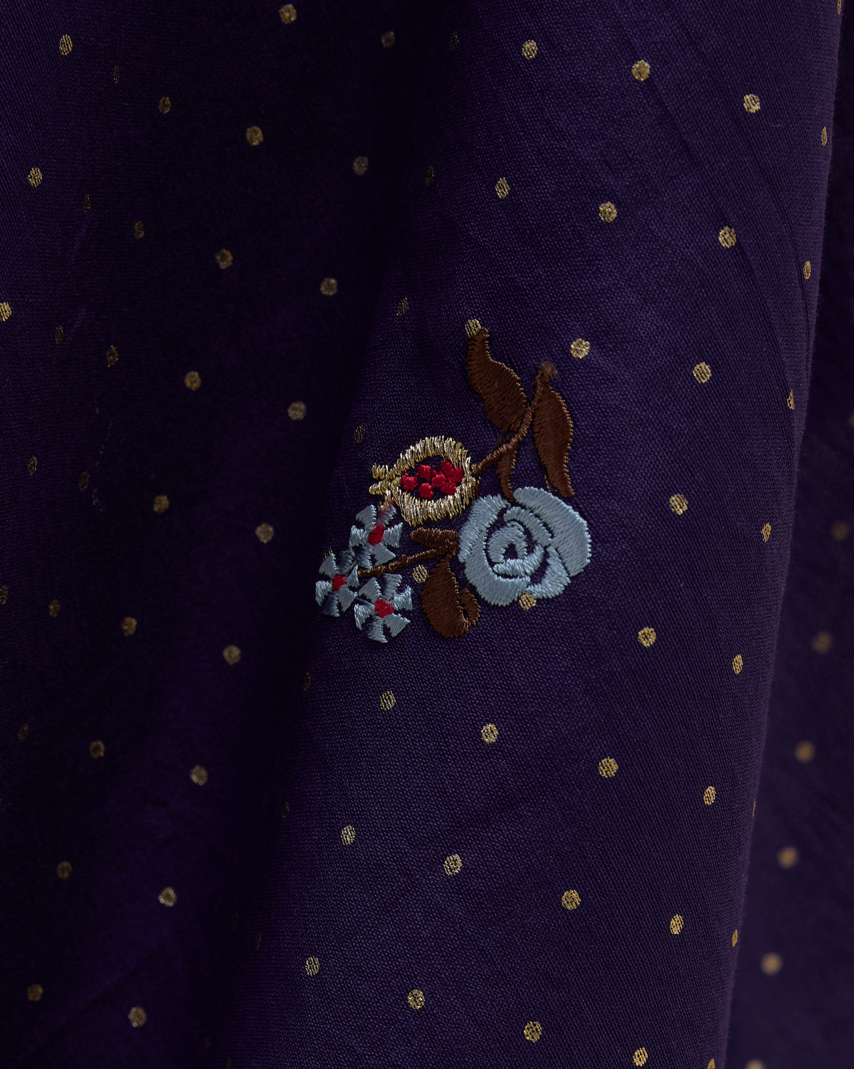 Close-up of blue floral embroidery on a purple Midnight Dance Sari.