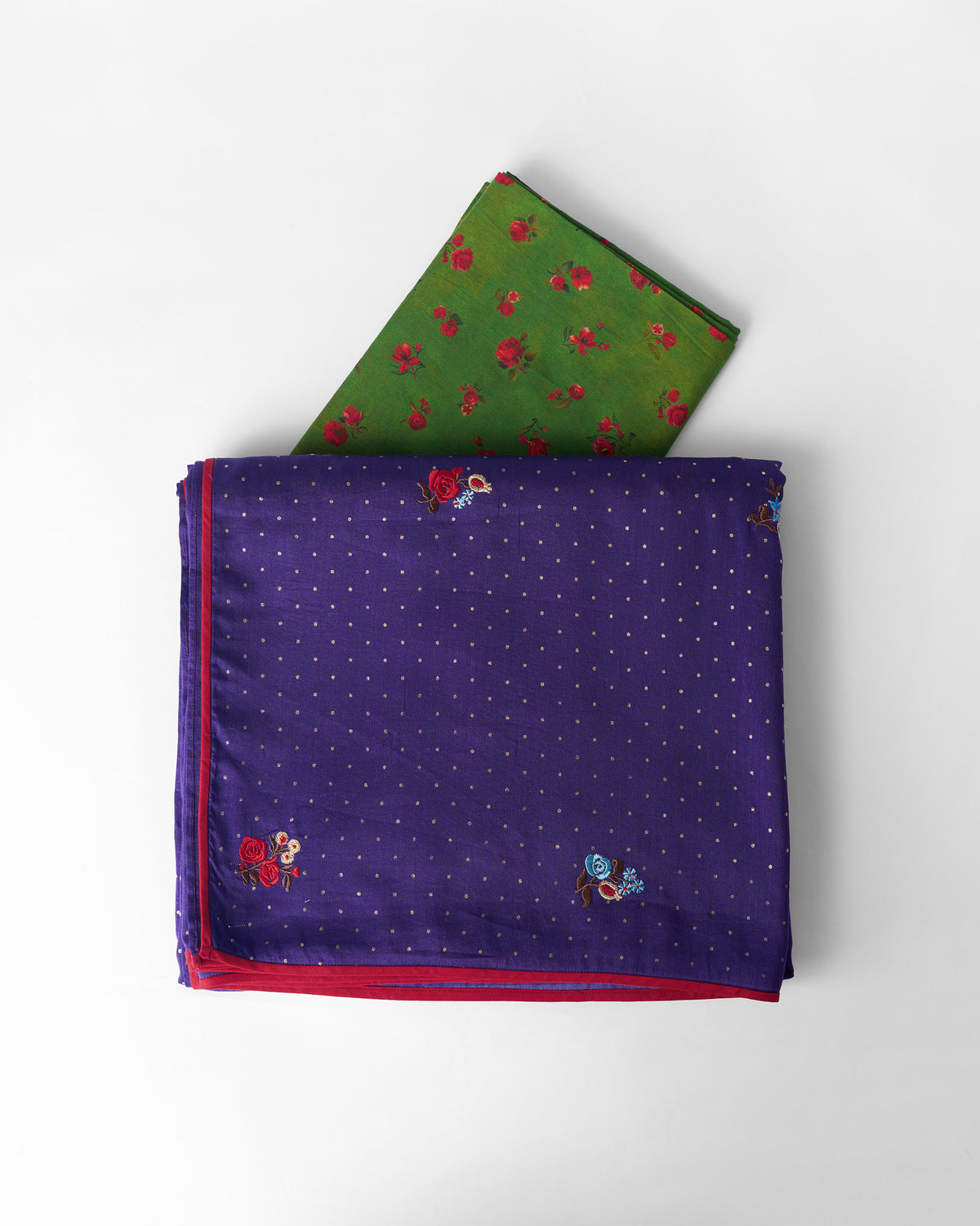 Purple Midnight Dance Sari fabric with floral embroidery laid beside a green blouse piece.