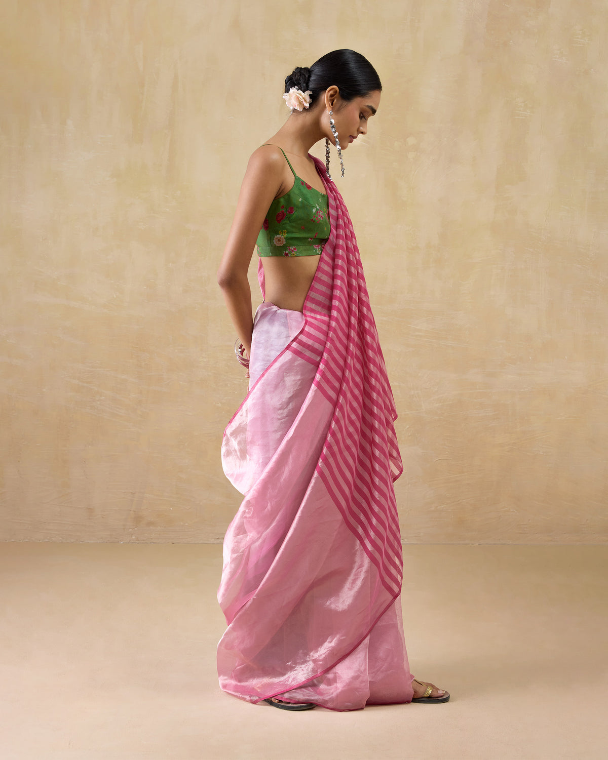 Side view of a blush pink Blush sari with a pink and silver striped pallu.