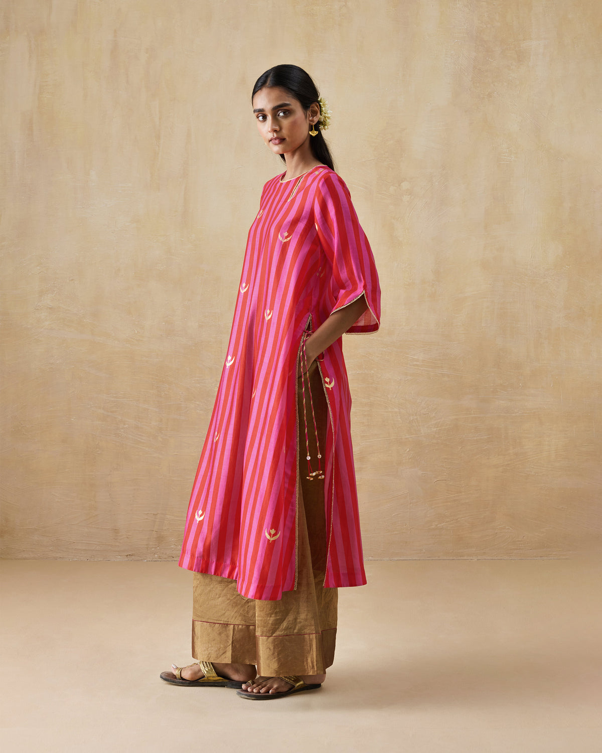 Side view of a red and berry striped Galaxy kurta with a deep side slit.