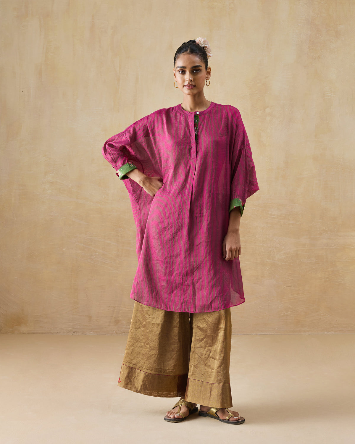 Person wearing a fuchsia and green metallic tissue Lazy Sunday tunic.