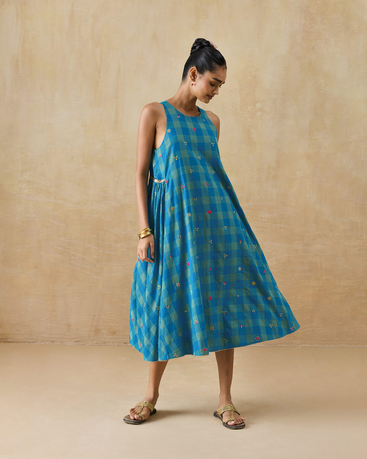 Person wearing a cerulean and yellow check Nimbus dress.