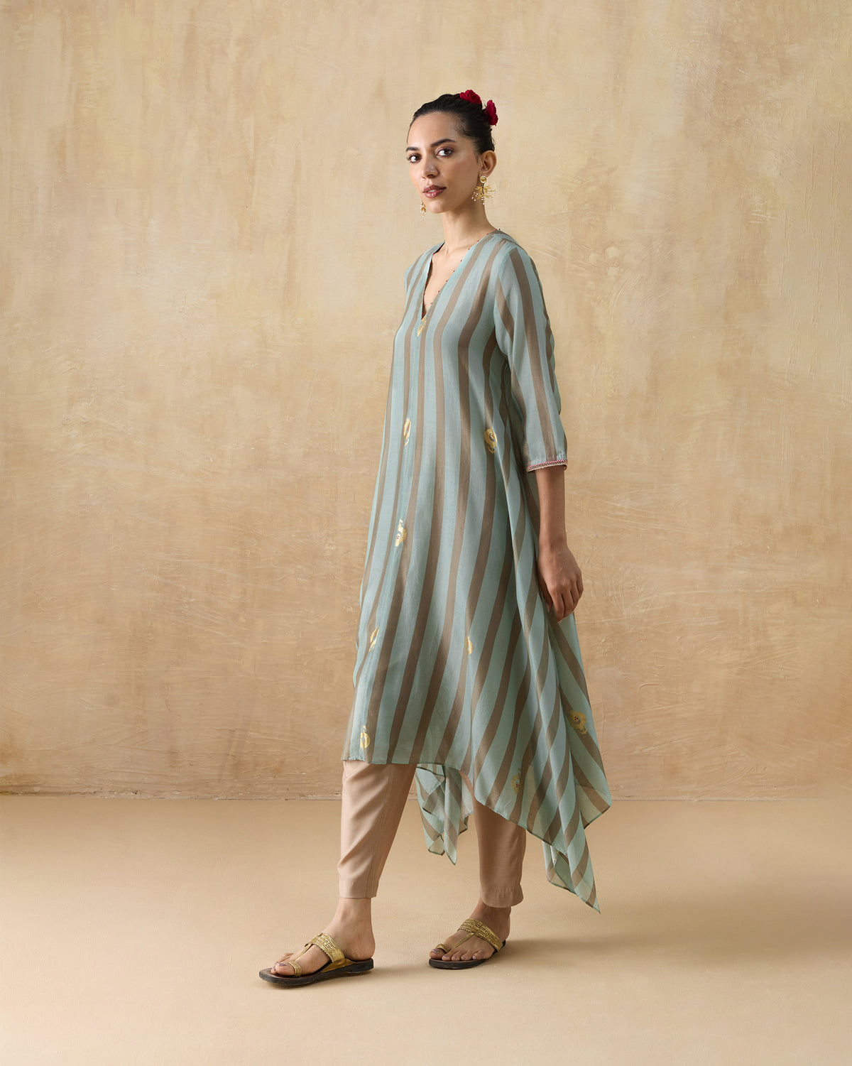 Person wearing a grey and aqua striped Midnight Club kurta with a handkerchief hem.