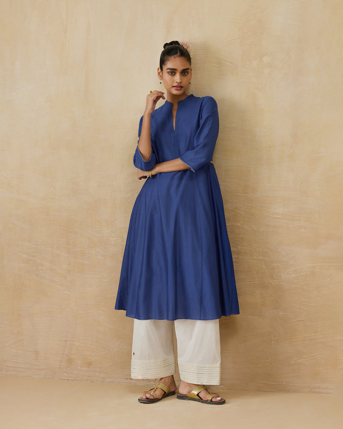 Person wearing a cobalt Moonsong kurta with an A-line flare.