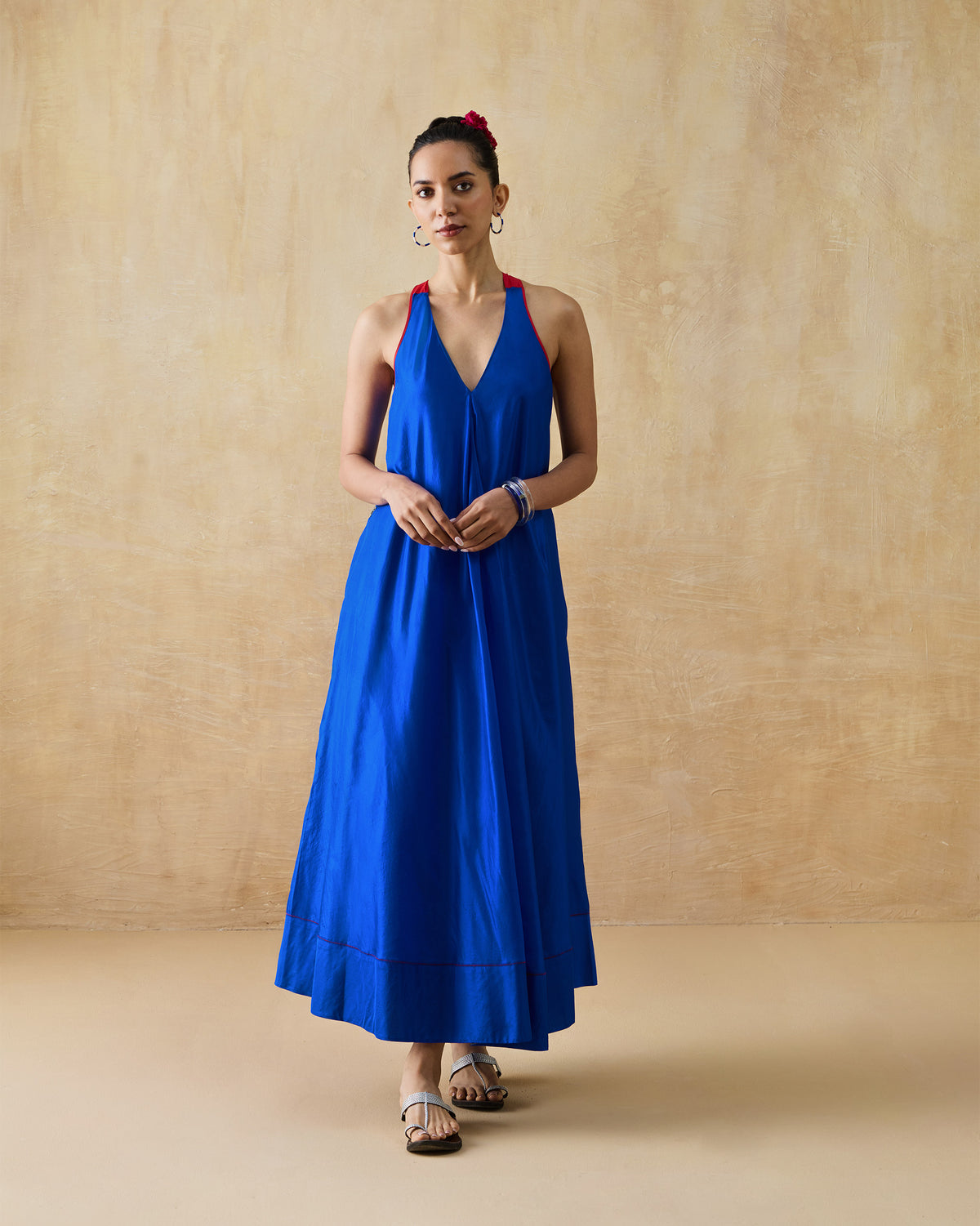 Person wearing a sleeveless cobalt blue Akira Twist Back Dress.