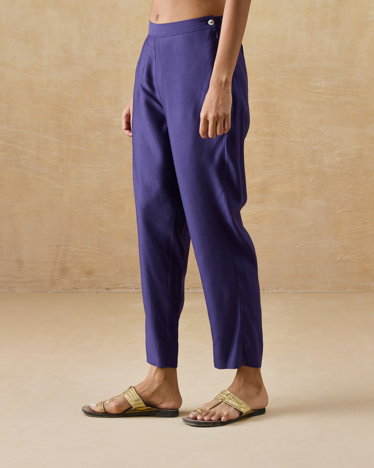 Side view of purple Darjeeling pants with a side button closure.