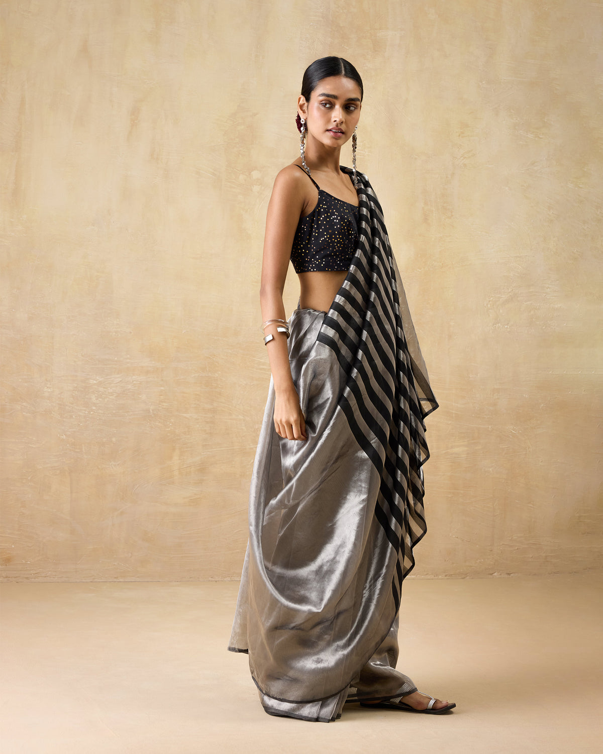 Side view of a silver Party Stripes sari showing the metallic drape and striped pallu.