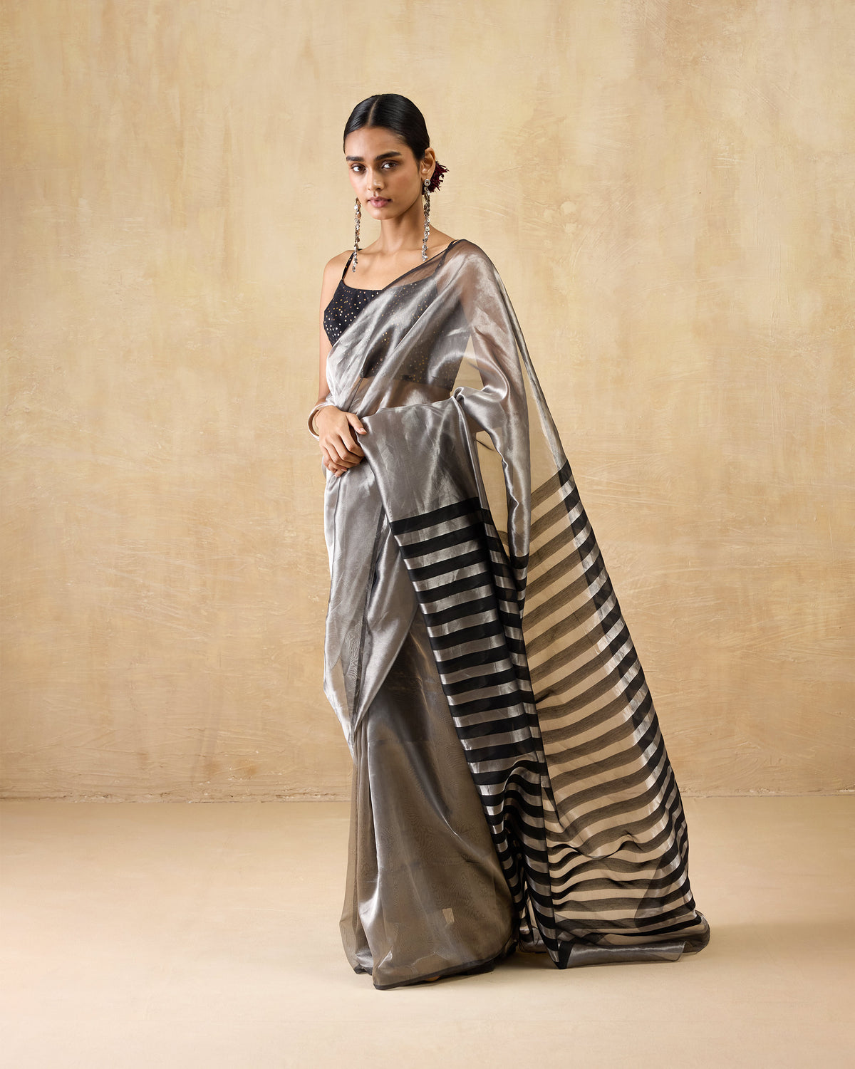Person wearing a silver metallic Party Stripes sari with a black striped pallu.