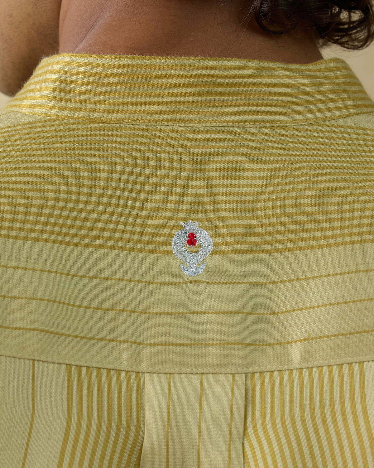 Close-up of a Voyage Kurta back yoke showing zari anaar embroidery.