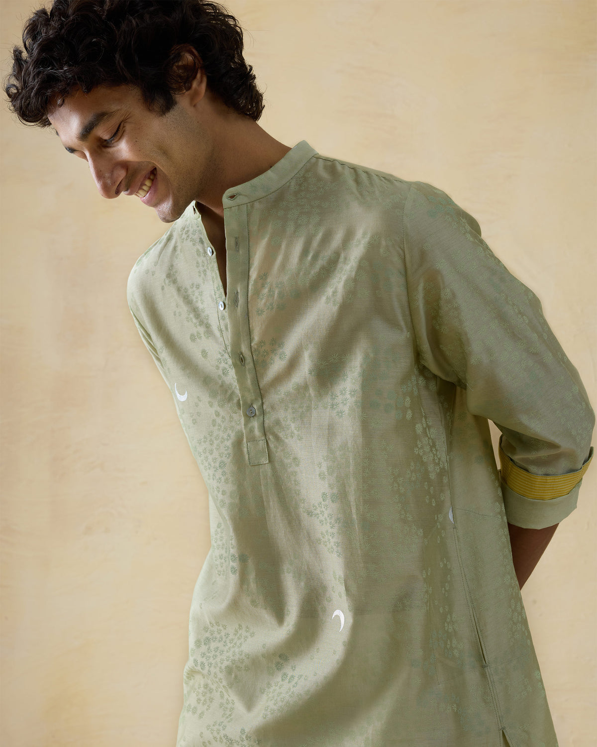 Mint green Bageecha kurta with moonlit foil print and yellow cuff lining.