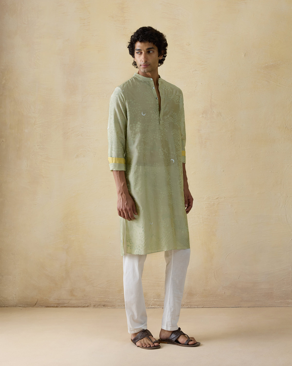 Person wearing a mint green Bageecha kurta with moon and star foil print.