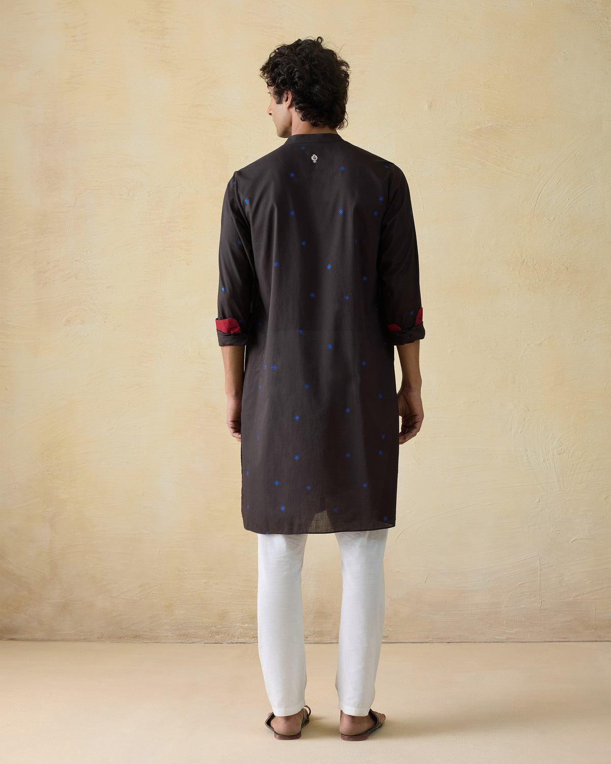 Back of a brown Gala Kurta with blue star dots.