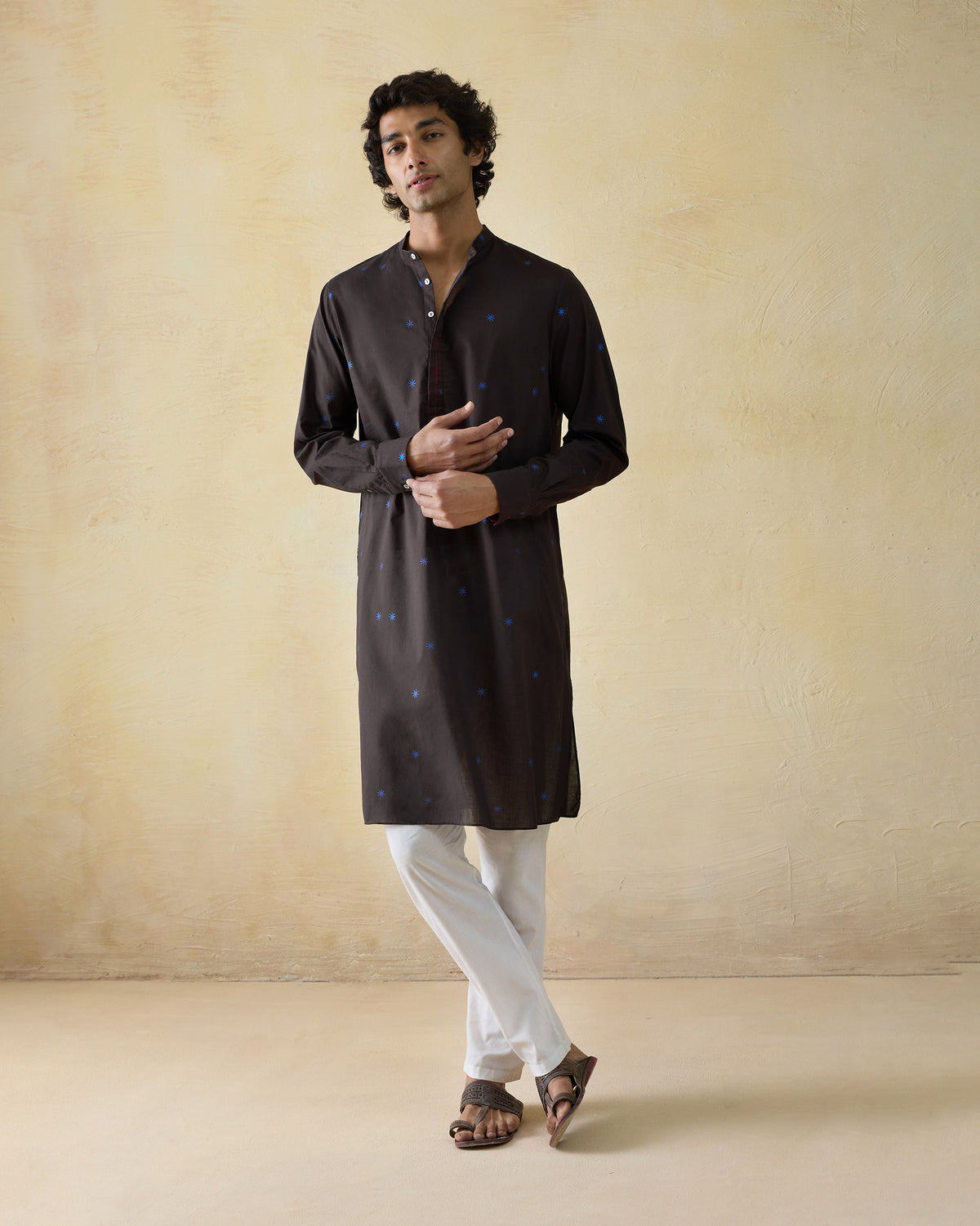 Person wearing a brown Gala Kurta with blue star dots.