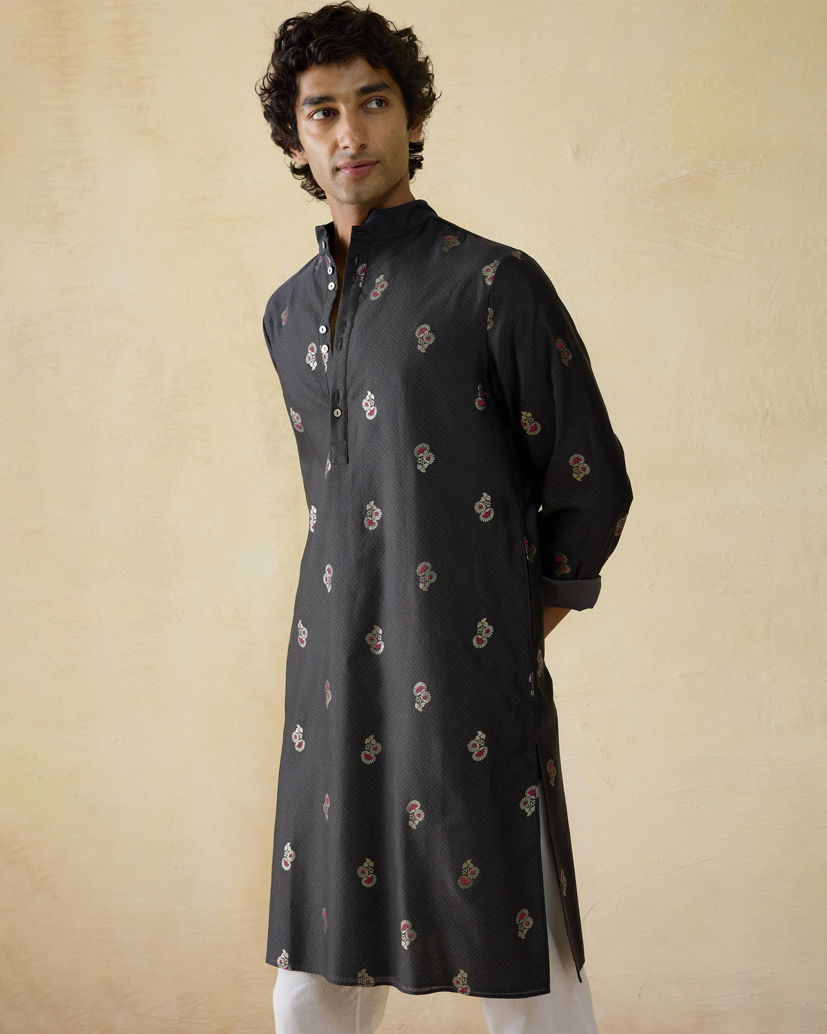 Person wearing a black printed Rey kurta with a short open placket.