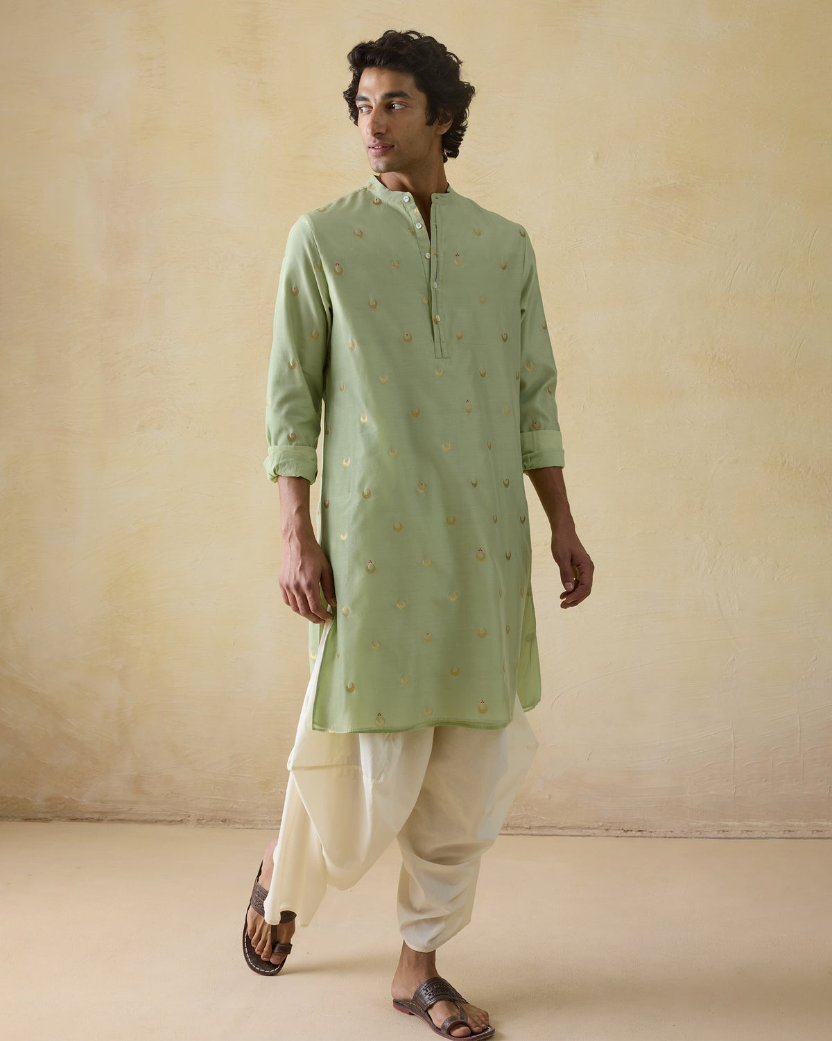 Person wearing a mint green astral kurta with gold valley print.
